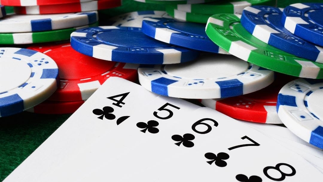 Cards and casino chips displayed on a poker table.