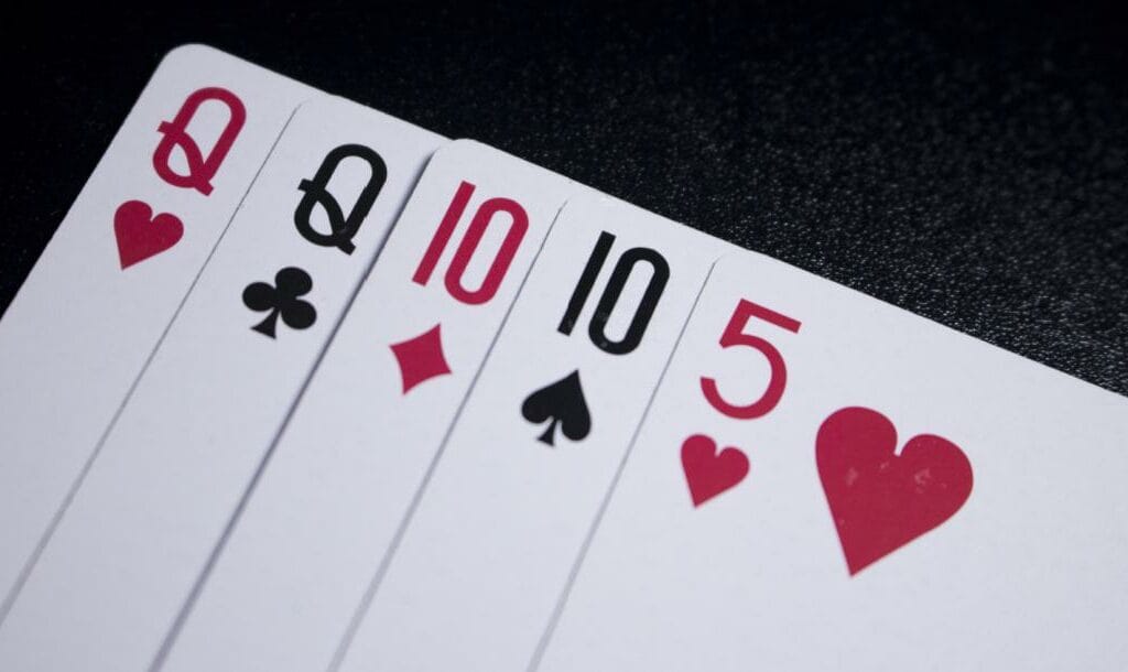 A poker hand with two queens, two tens and a five