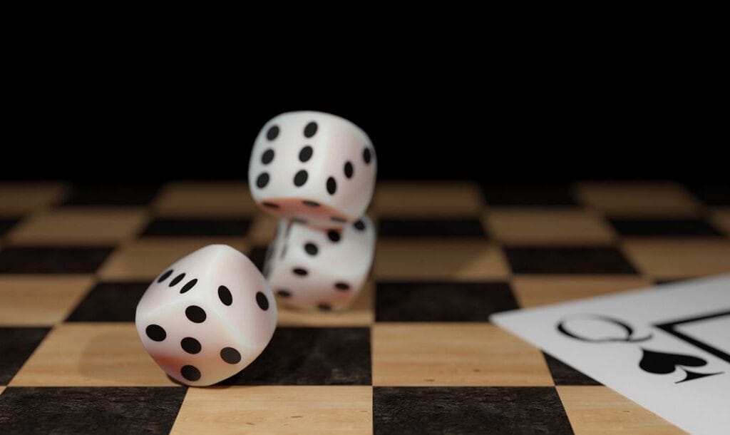 Dice and playing cards on a chessboard.