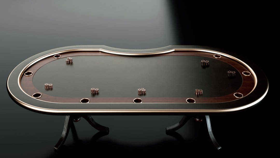 An empty black poker table with gold and wood finishings. There are gold and black poker chips on the table.