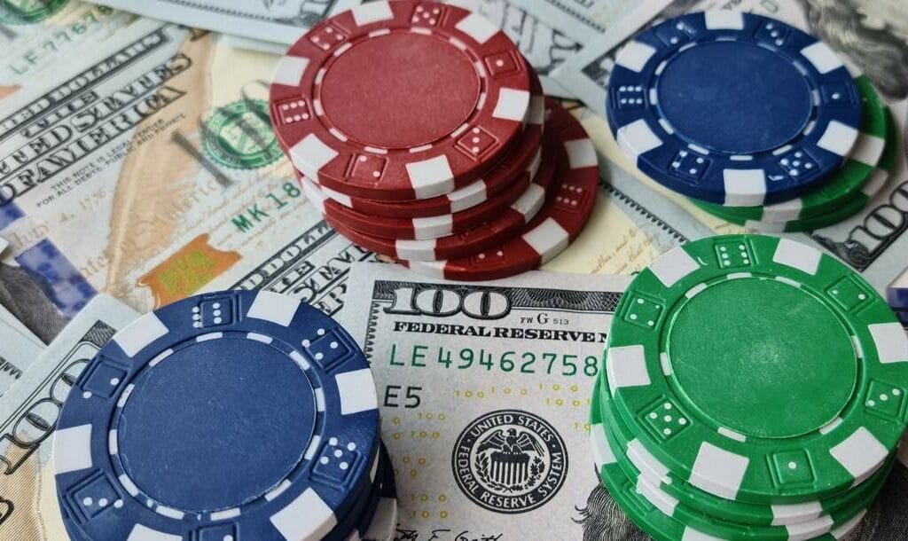 Poker chips stacked on top of dollar bills