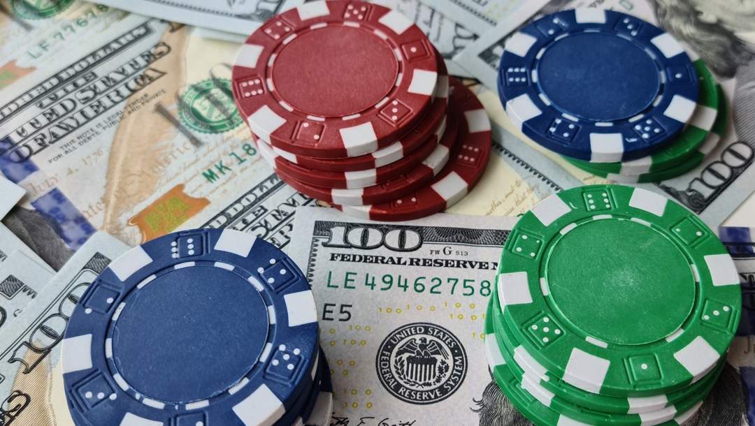 Poker chips stacked on top of dollar bills