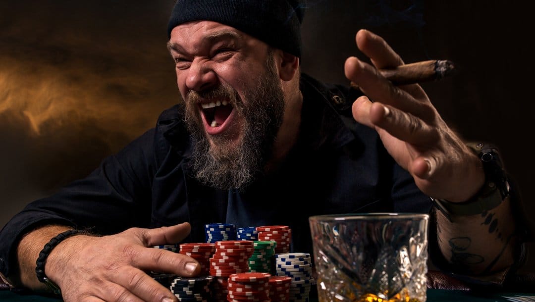 An angry poker player shouting. He protects his poker chips with one hand and has a cigar in the other hand.