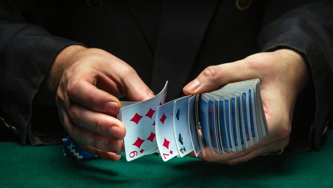 Male hands riffle a deck of playing cards