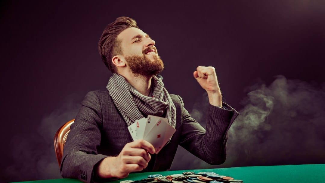 A man celebrates winning a game of poker