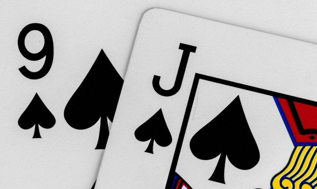 close up of a jack and nine of spades playing cards
