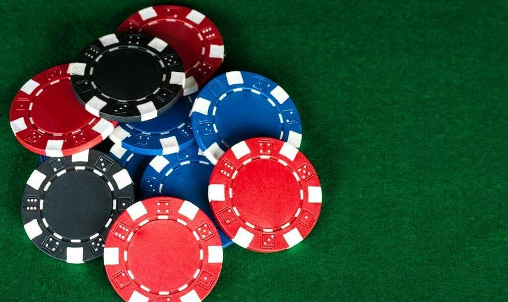 top view of a pile of poker chips on a green felt poker surface