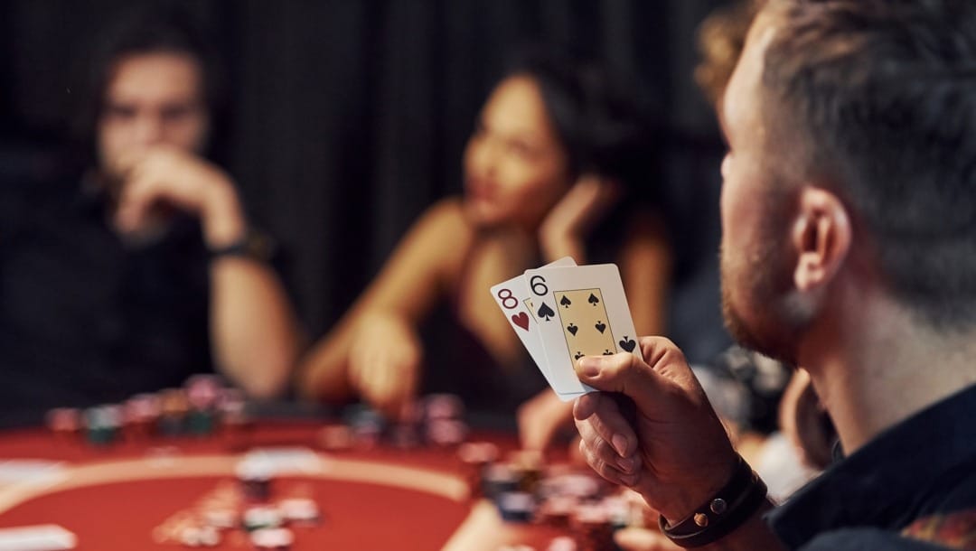 Group of young people playing poker in a casino together