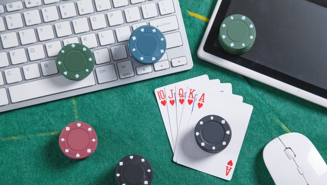 Computer keyboard, mouse, playing cards and chips