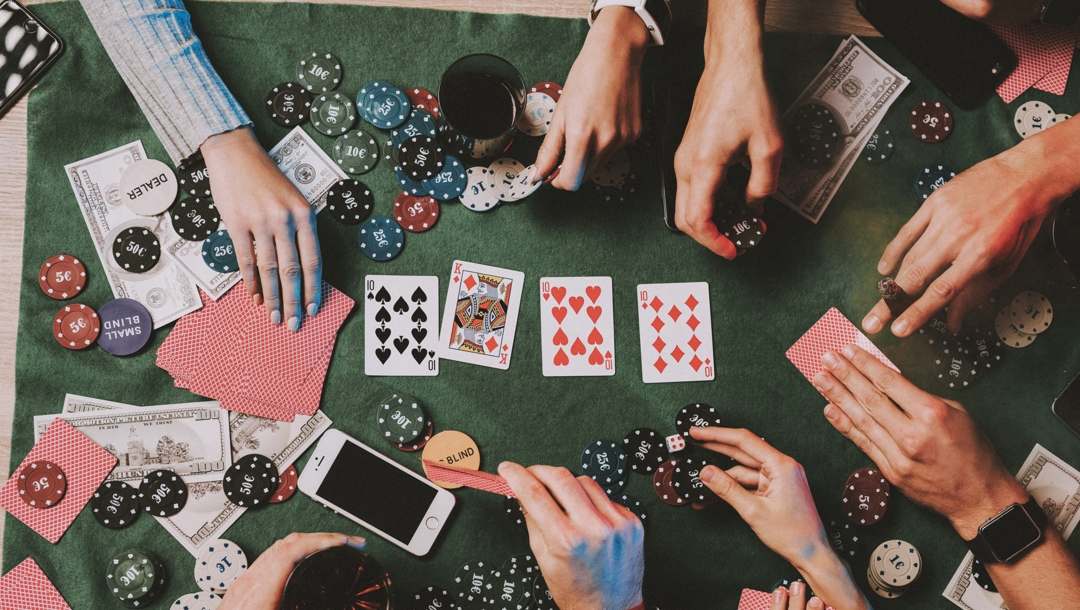 Young friends playing poker at home