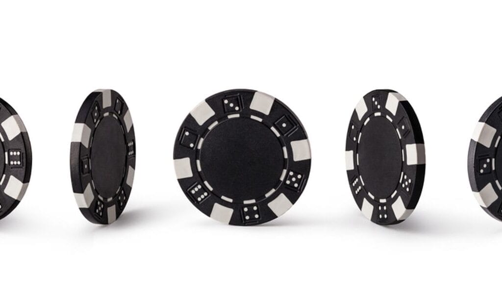 Black poker chips displayed in every angle.