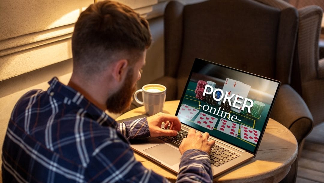 Young man playing online poker via laptop