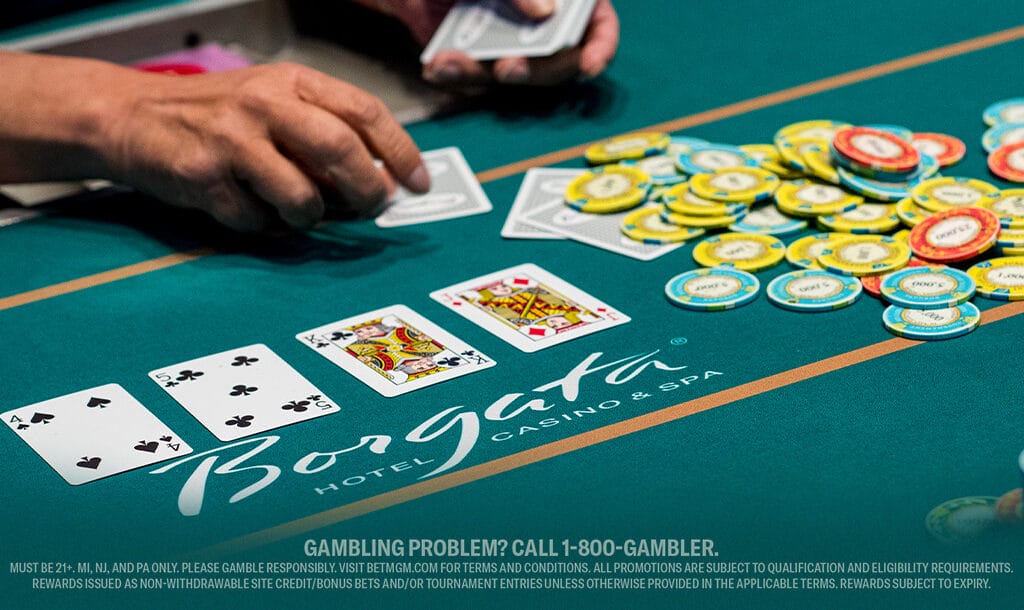 Live blackjack table at Borgata Casino & Spa, showing a player’s hand, stacked chips, and face-up cards during an active round of casino play.