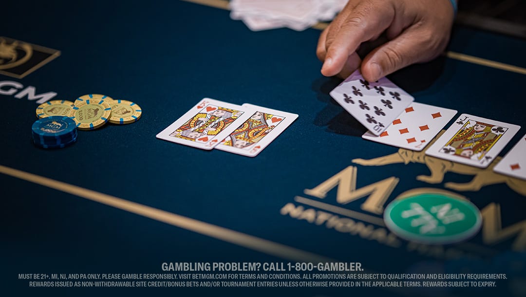 A poker table set with various playing cards and chips, indicating an ongoing game.