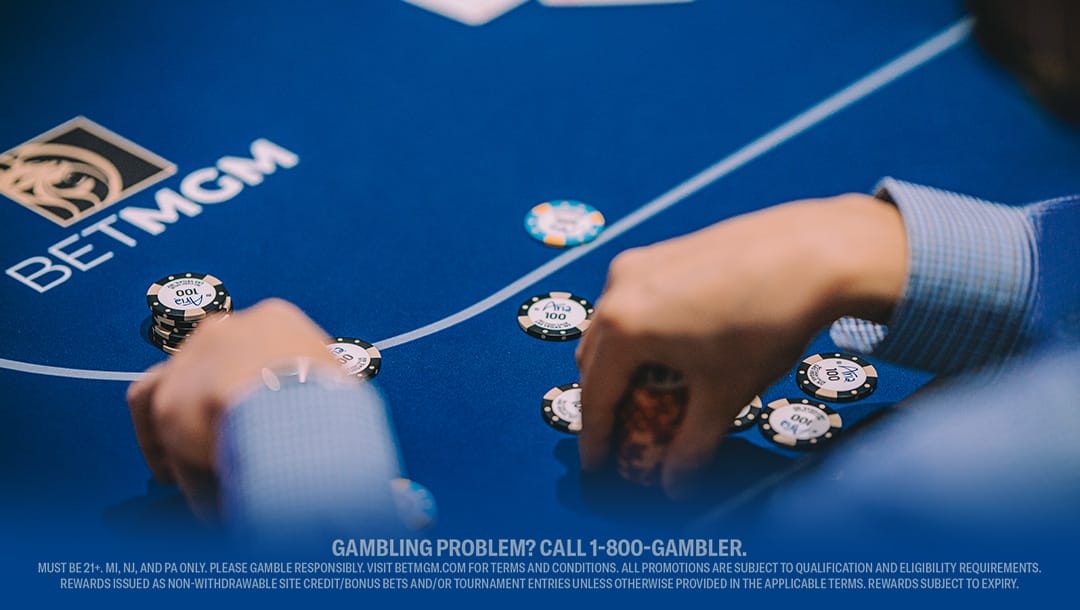 A close-up of a poker table featuring cards and stacks of chips ready for play.