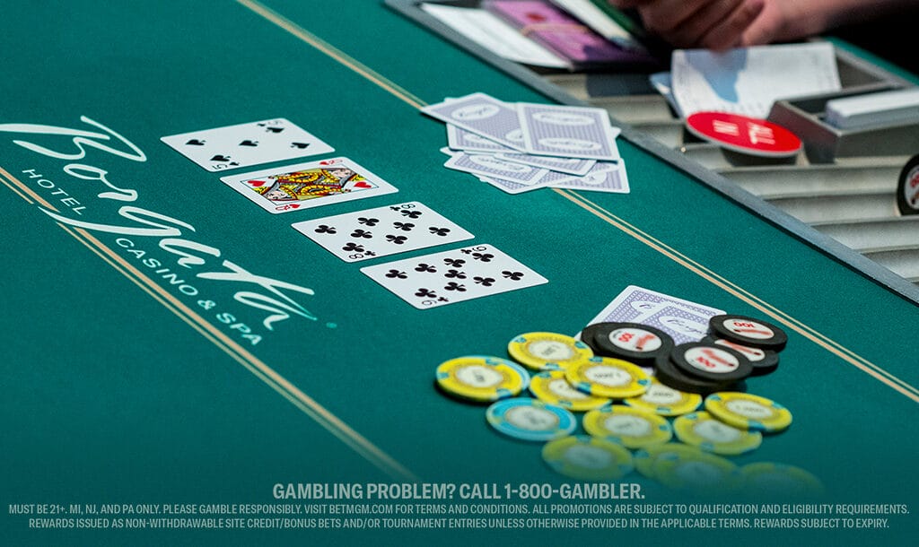 A close-up of a poker table featuring cards and stacks of chips ready for play.