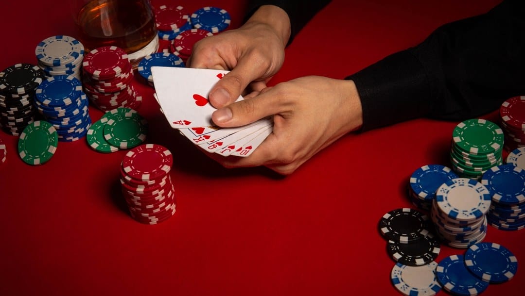 Game chips and dice lie on the table against a red background.