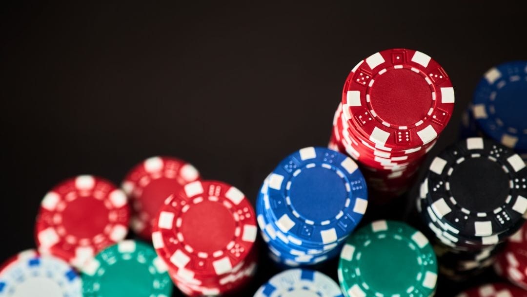 Stacks of poker chips on a black table.