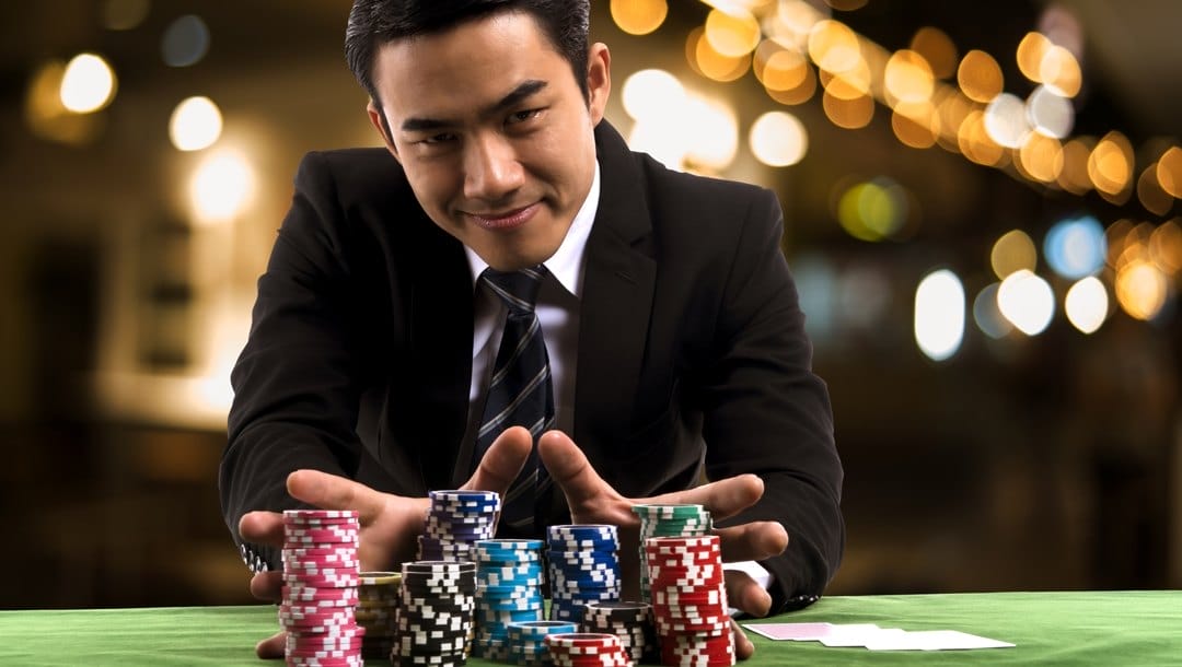 A man pushes poker chips away from him