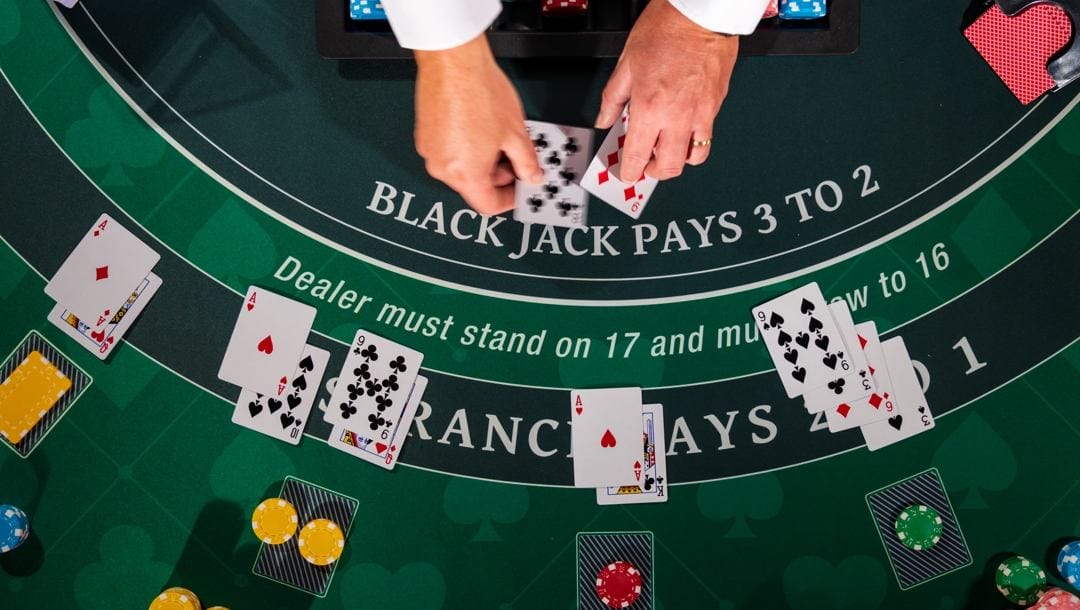 A croupier deals cards on a blackjack table