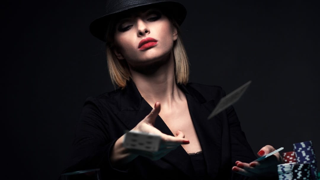 Young woman wearing a hat plays poker