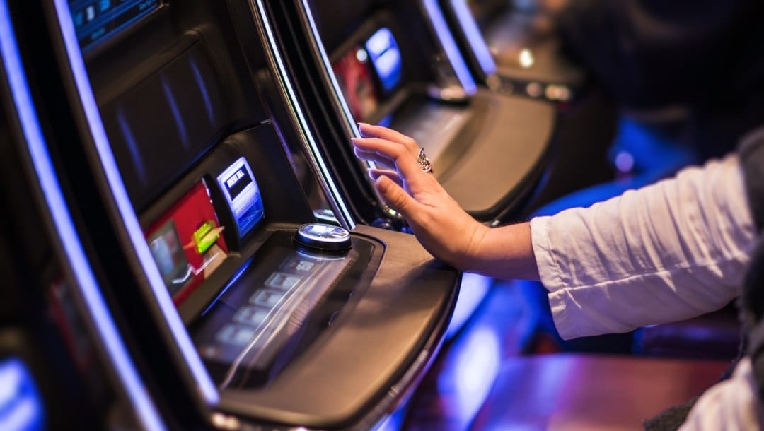 A woman plays video poker at the casino