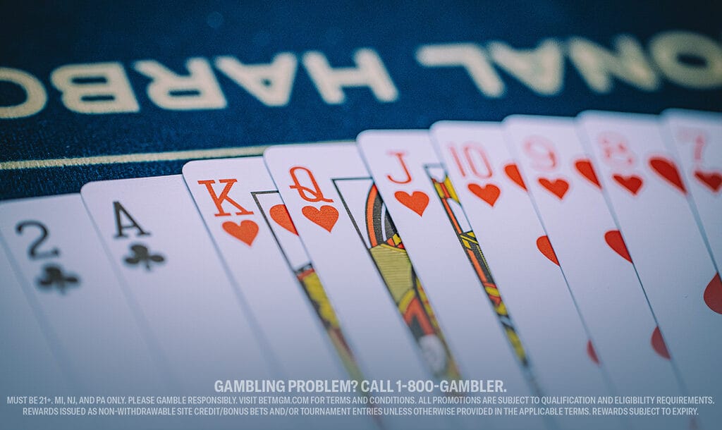 A hand of playing cards featuring a royal flush in hearts, with text at the bottom about responsible gambling. The scene conveys excitement and caution.