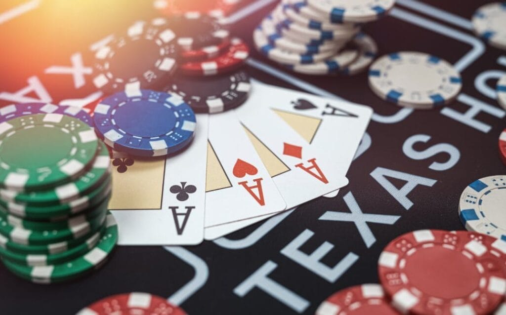 Poker chips and cards on a table labeled "TEXAS" indicate a game of poker.