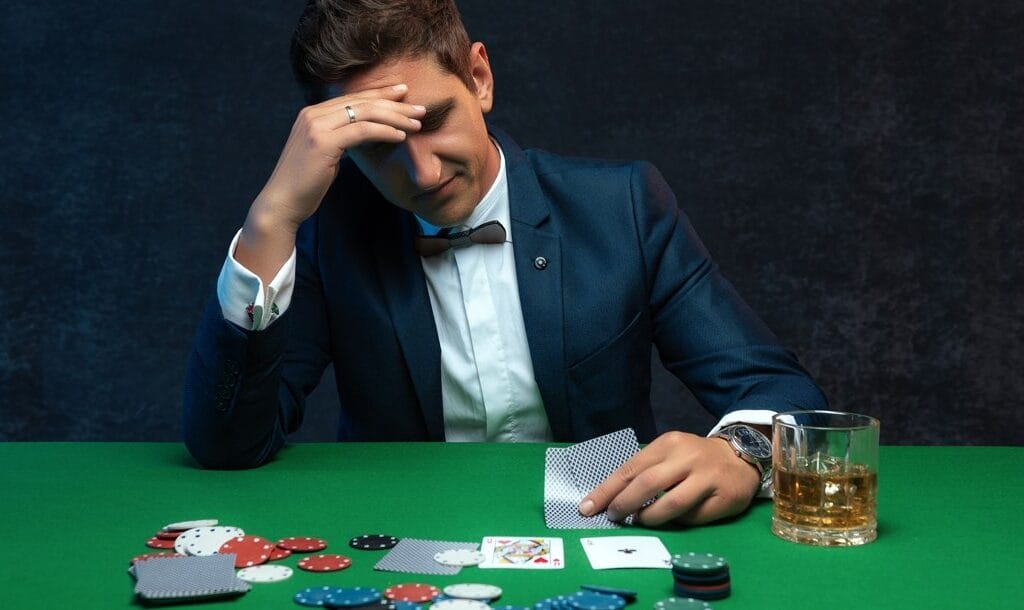 A-man-looks-with-concern-at-his-poker-cards-Weak-ace-hands