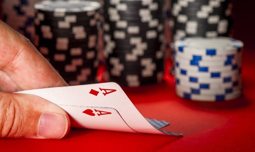 A-man-checks-his-hole-cards-Weak-ace-hands