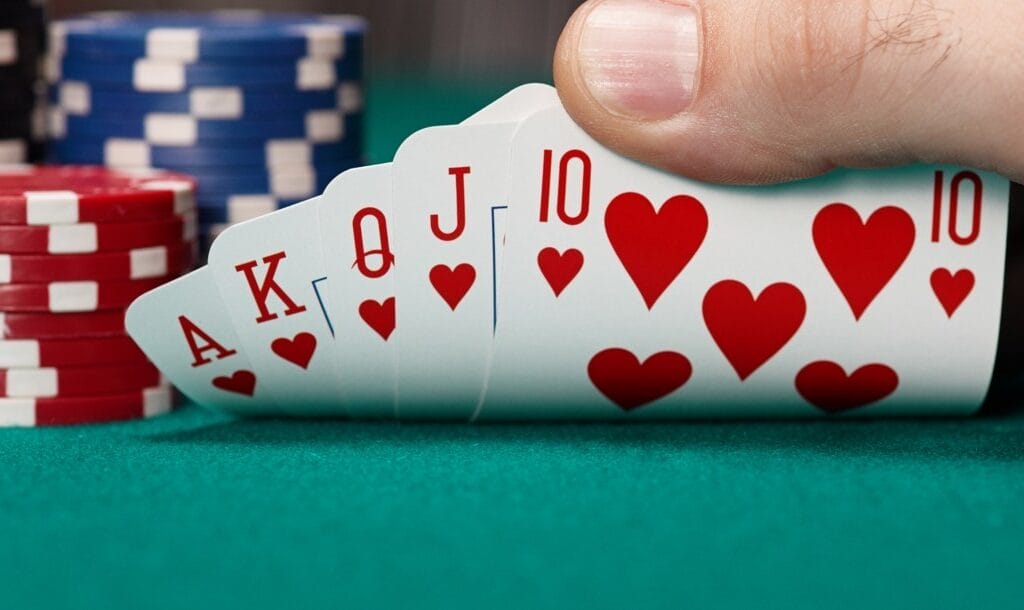 A-poker-player-checks-their-hand-and-sees-a-royal-flush-Royal-flush