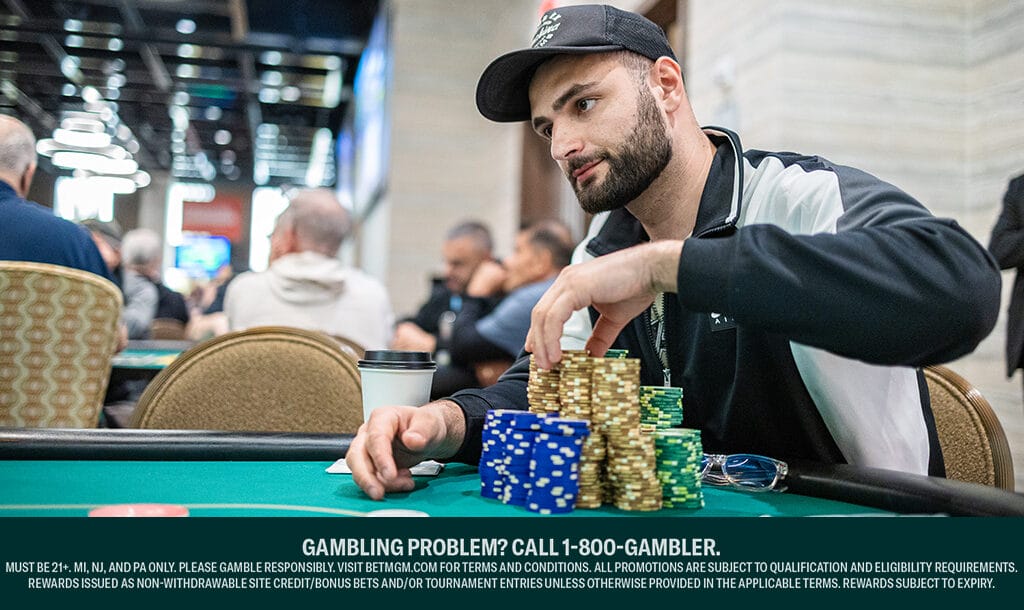 A professional poker player choosing poker chips from his large stacks.