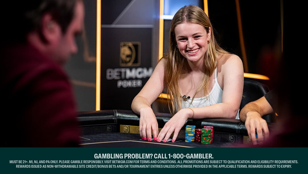 Abby Merk sits smiling at a poker table with a BetMGM Poker sign in the background.