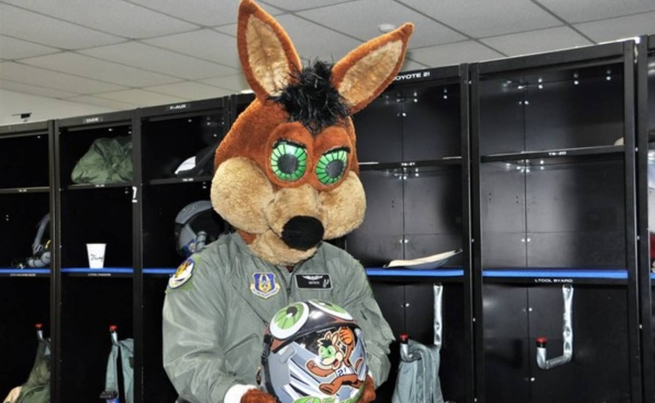 San Antonio Spurs team mascot The Coyote  holding mascot helmet in locker room