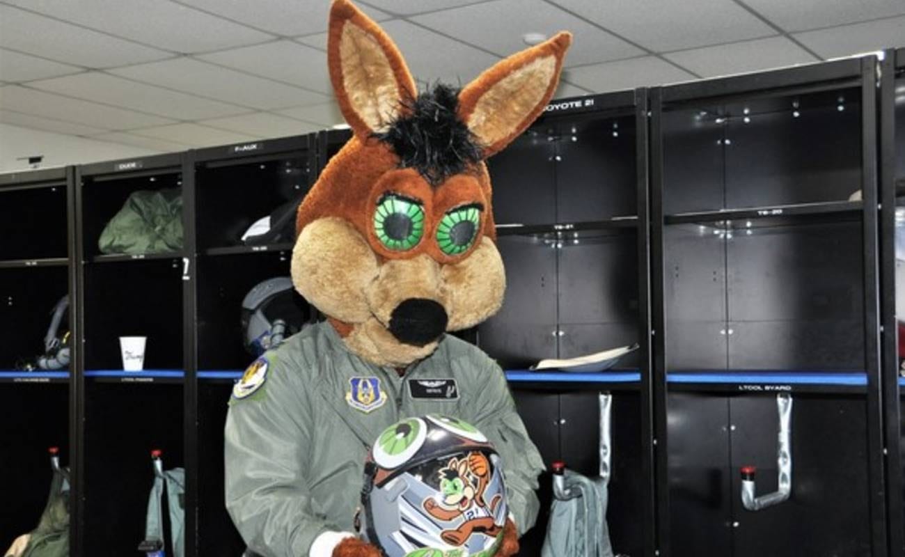 San Antonio Spurs team mascot The Coyote holding mascot helmet in locker room