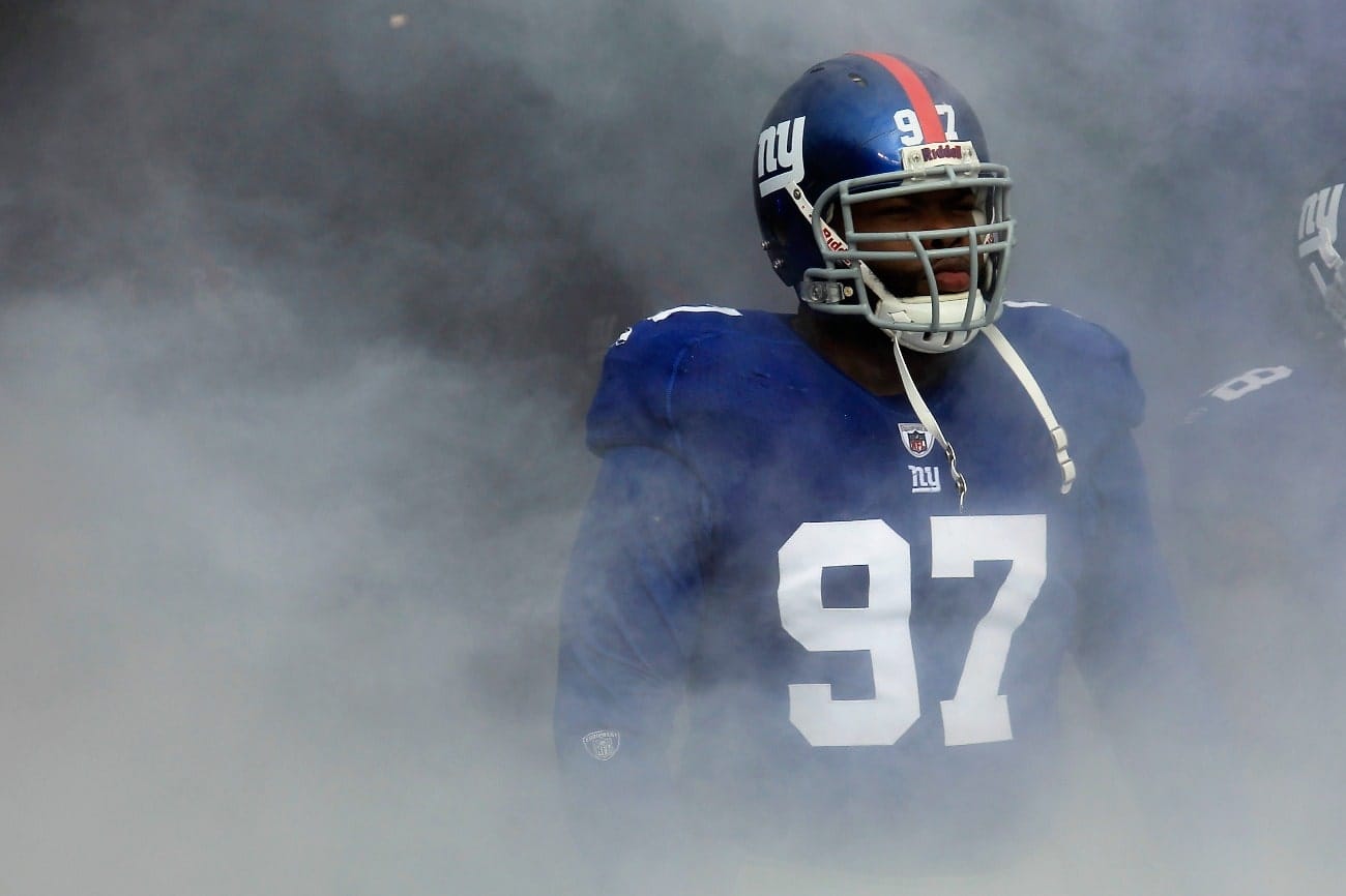 Smoke fills the tunnel as Linval Joseph #97 of the New York Giants waits to take the field during player introductions against the Atlanta Falcons during their NFC Wild Card Playoff game at MetLife Stadium on January 8, 2012 in East Rutherford, New Jersey.