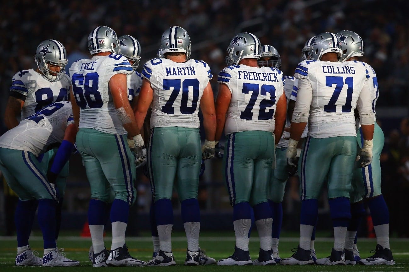 The Dallas Cowboys offense huddles during play against the Seattle Seahawks at AT&T Stadium on November 1, 2015 in Arlington, Texas.