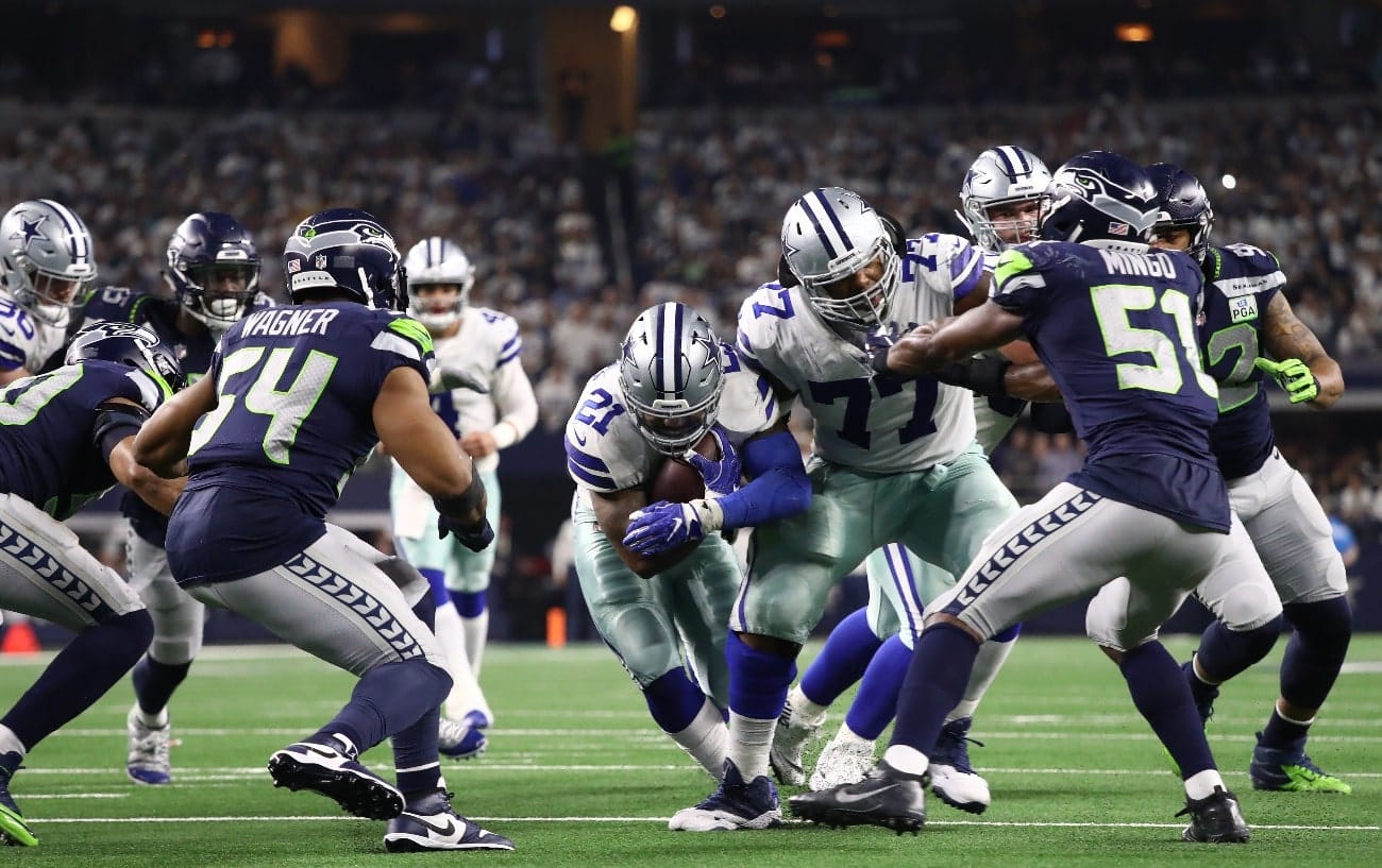 Ezekiel Elliott #21 of the Dallas Cowboys runs the ball against the Seattle Seahawks in the Wild Card Round at AT&T Stadium on January 05, 2019 in Arlington, Texas.