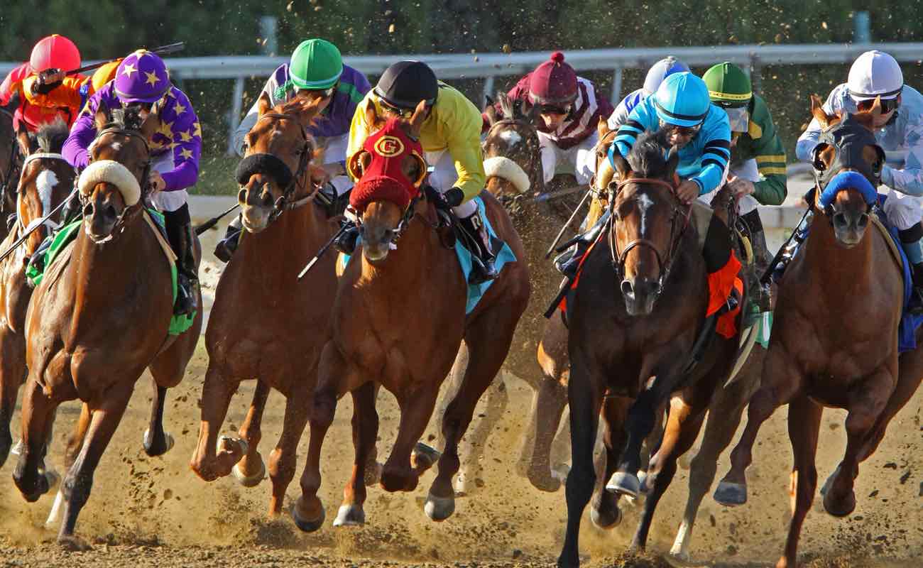 Front view of jockeys storming down the homestretch at Santa Anita Park